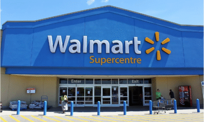 Walmart storefront with signage and customers entering